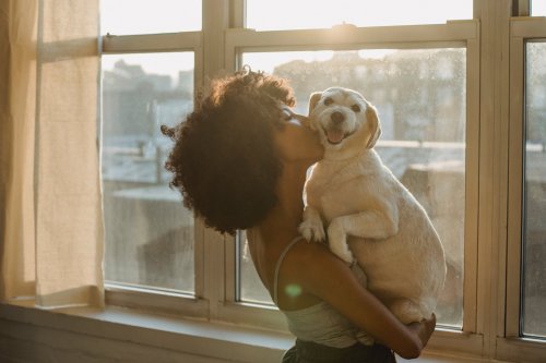 woman kissing her dog