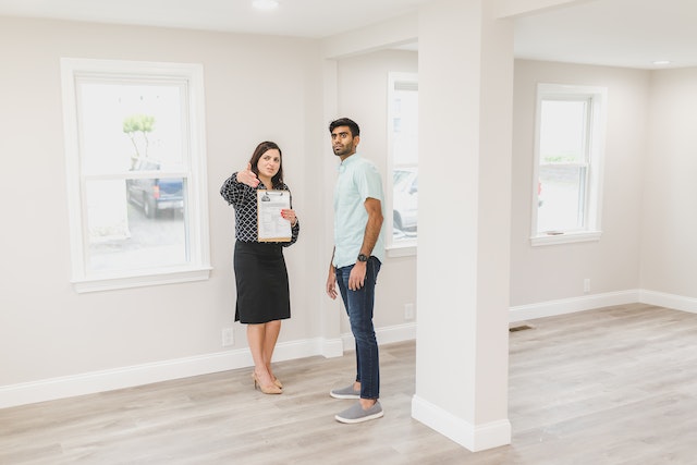 two people showing an empty property